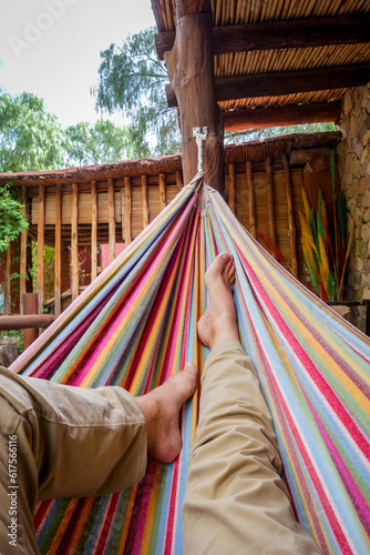 Man relaxing in a colored hammock. subjective view