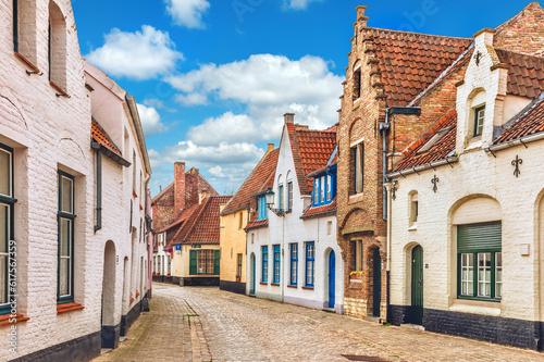 Vintage street in Bruges Belgium with blue sky and white cloud. Europe landscape panorama old town.