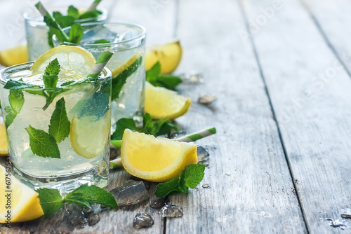 Chilled mint lemonade with mint leaves and fresh lemon. Copy space background.