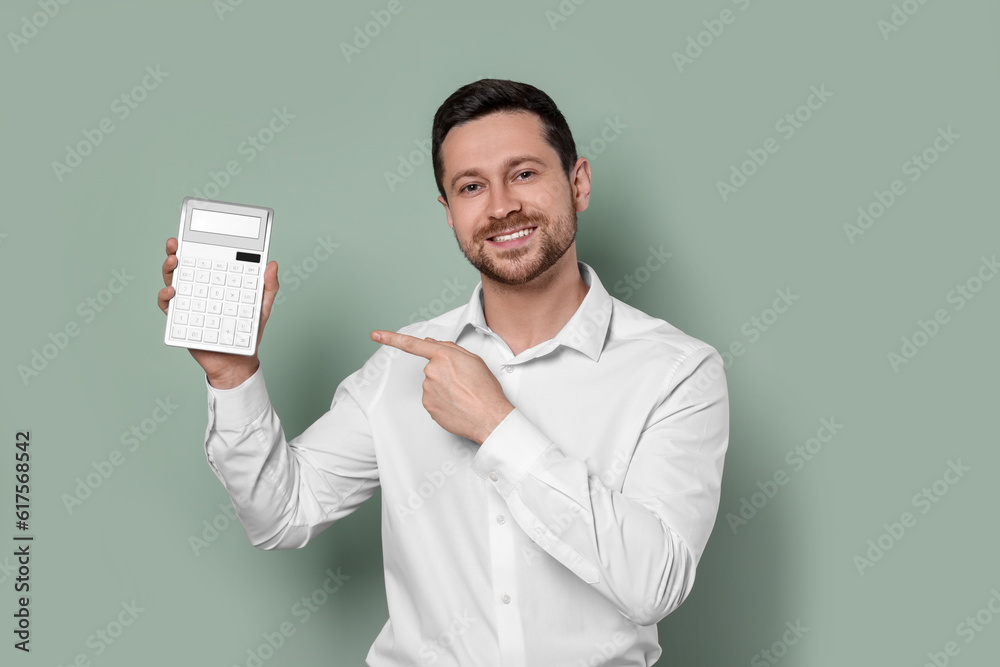 Happy accountant showing calculator on olive background Happy accountant showing calculator on olive background