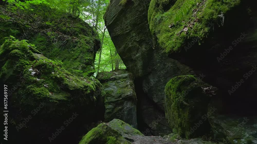 Stone Cave Rocks in Green Moss Covered Forest Landscape Stone Cave Rocks in Green Moss Covered Forest Landscape
