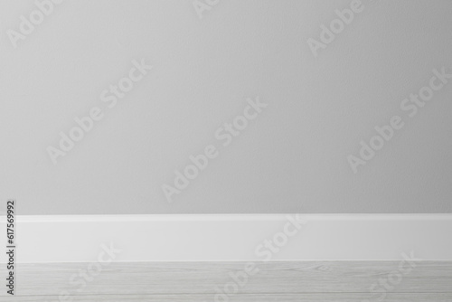 White plinth on laminated floor near wall indoors