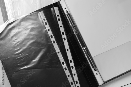 Folders with punched pockets on white table, flat lay