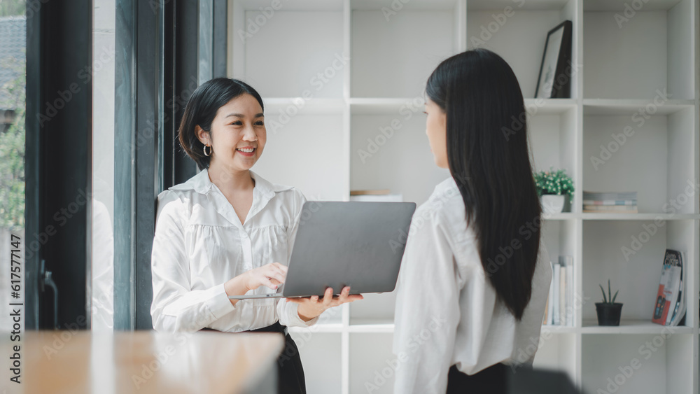 Business woman talking to her colleague during a meeting in a boardroom, Business concept. Business woman talking to her colleague during a meeting in a boardroom, Business concept.