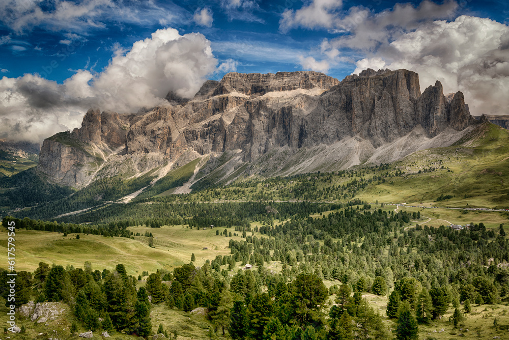 Beautiful view on the italian mountains of Val Gardena in summer season seen from path near Sella Pass with sky and clouds at the horizon
