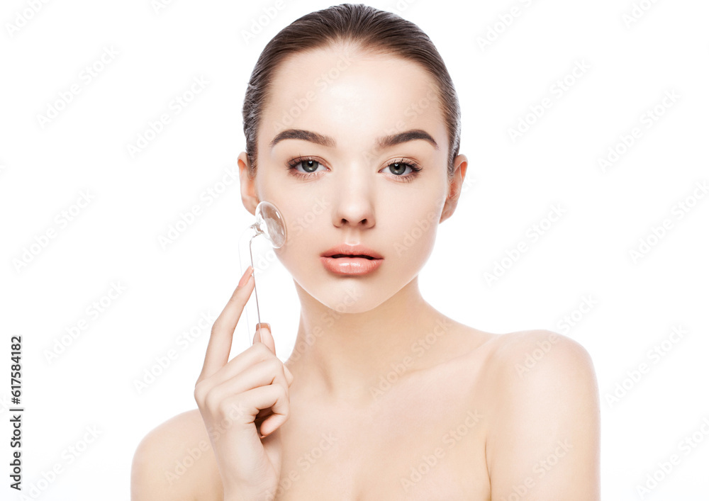 Beautiful girl holding drainage massage face roller on white background