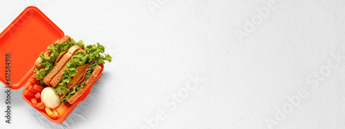 Lunch box of tasty food on light background with space for text