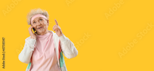 Senior woman talking by mob...