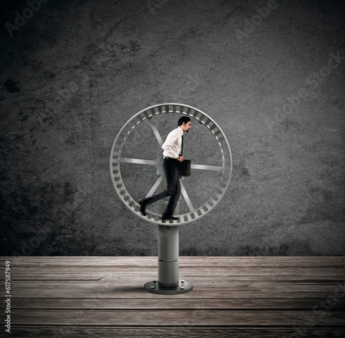 Businessman running on the hamster wheel. looping life concept