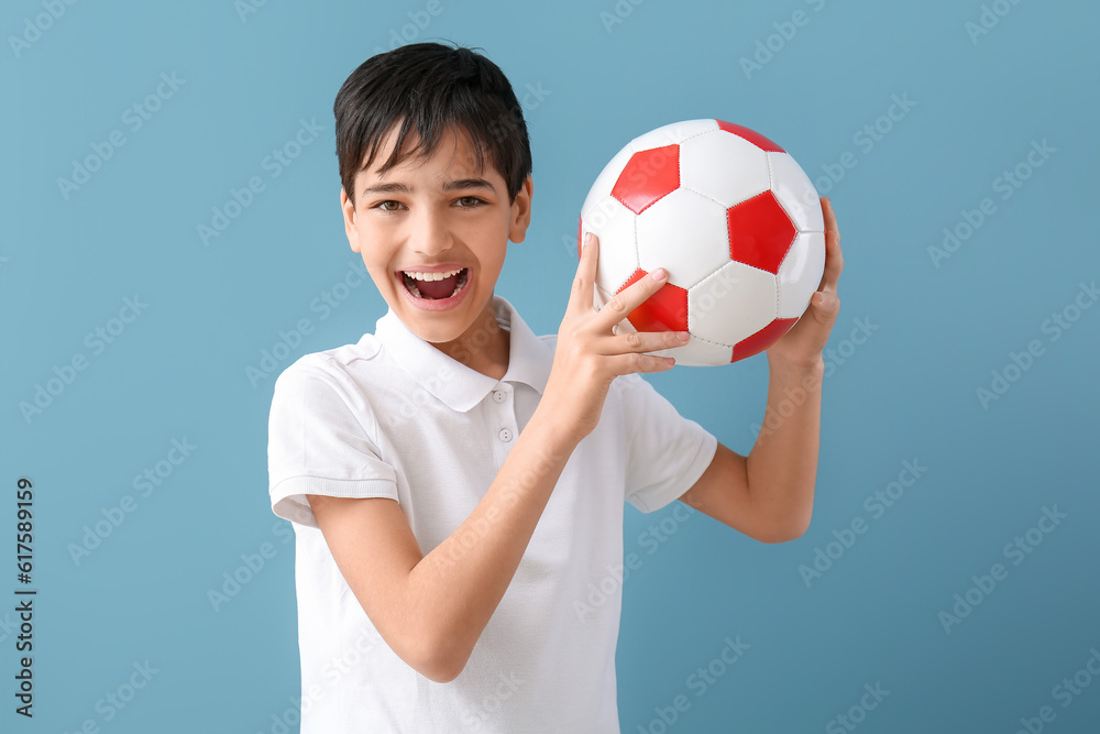Little boy with soccer ball on blue background Little boy with soccer ball on blue background