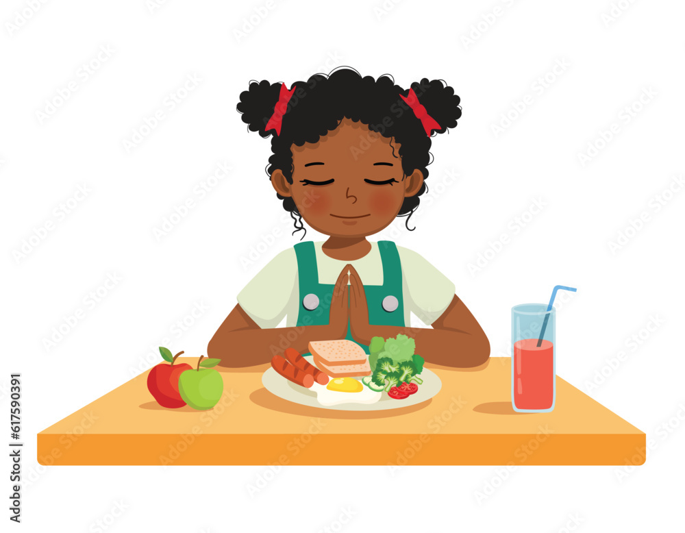 Little African girl praying before eating breakfast at the table Little African girl praying before eating breakfast at the table