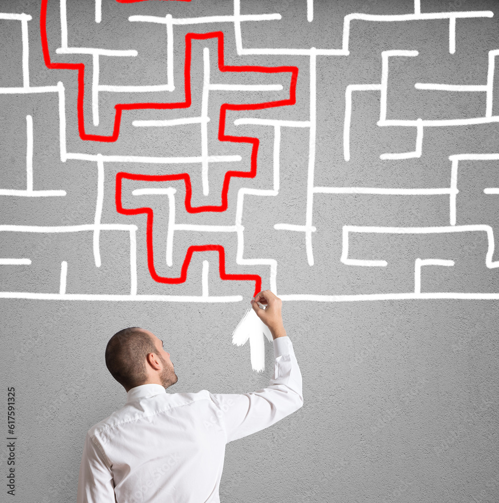 Businessman draws the solution of a labyrinth Businessman draws the solution of a labyrinth