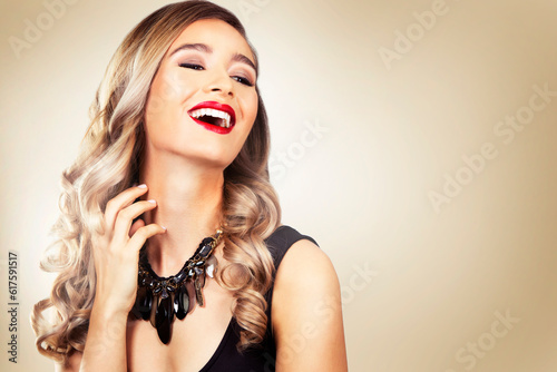 beautiful woman with dark makeup and red lipstick posing on light background