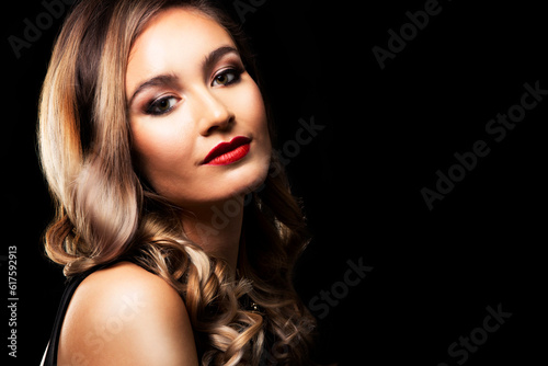 beautiful woman with dark makeup and red lipstick posing on black background