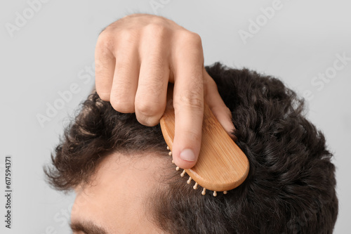 Young brunette man brushing...