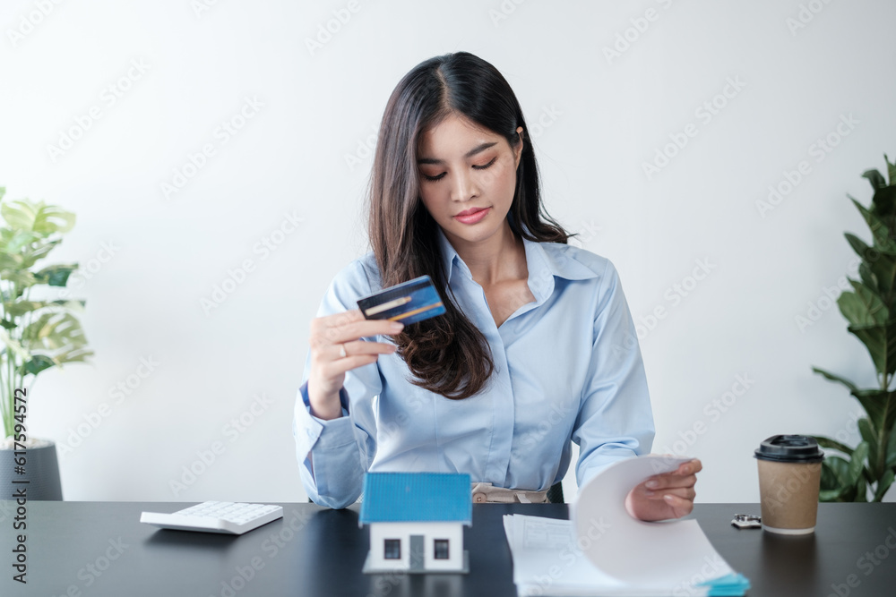 Closeup women holding hand credit card. Looking of a bill for online payments shopping in the morning. Closeup women holding hand credit card. Looking of a bill for online payments shopping in the morning.