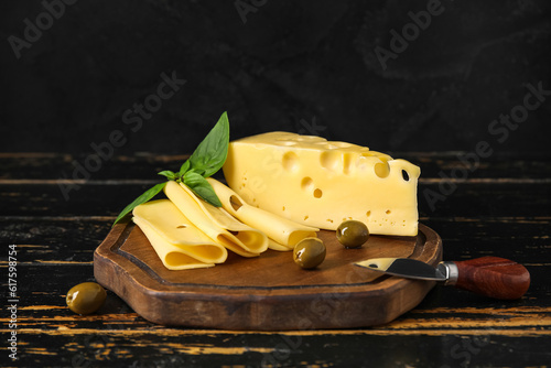 Foto Board with tasty Swiss cheese on table
