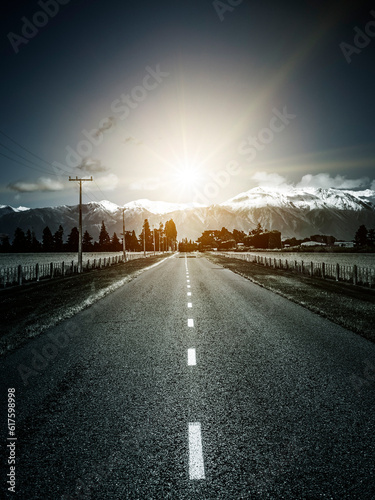 An image of a road to the alps with dramatic sun light