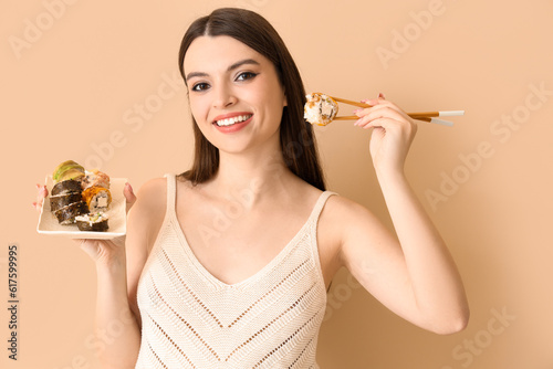 Young woman with sushi on b...
