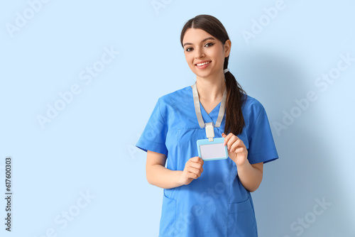 Female medical intern with badge on blue background