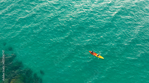 Aerial view of a kayak in the blue sea .Woman kayaking She does water sports activities.