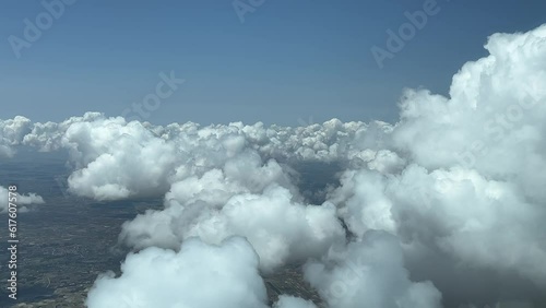 Flying across a sky with some tiny white cumulus in a hot summer day. A pilot’s point of view. photo