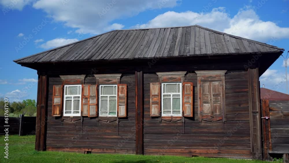 old wooden house against a blue sky with white clouds old wooden house against a blue sky with white clouds