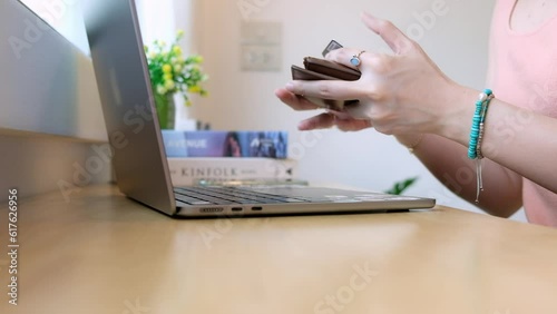 Female hands of cardholder holding credit card making e bank online payment. Woman consumer paying for purchase in web store using laptop technology.