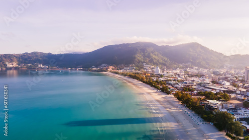 Drone Camera Aerial view of Patong town in Phuket, Thailand. The sea is beautiful in the summer, the sun is shining, the morning is comfortable.