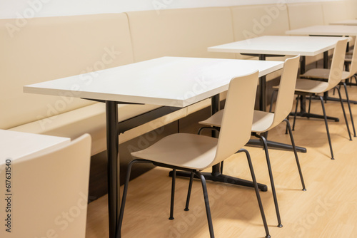 Inside a restaurant with white tables and chairs