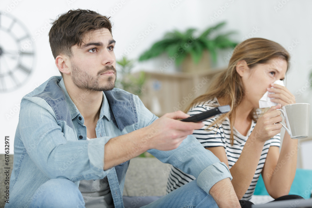 bored caouple on a couch watching tv bored caouple on a couch watching tv