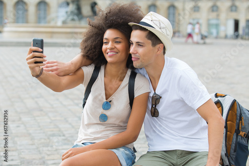 young hipster couple taking selfie while on city break