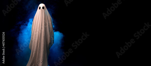Photography Scary ghost covered in sheet on a dark background in the smoke