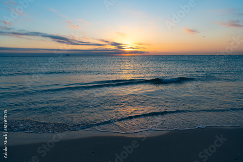 scenic sunset with sea water on the summer beach