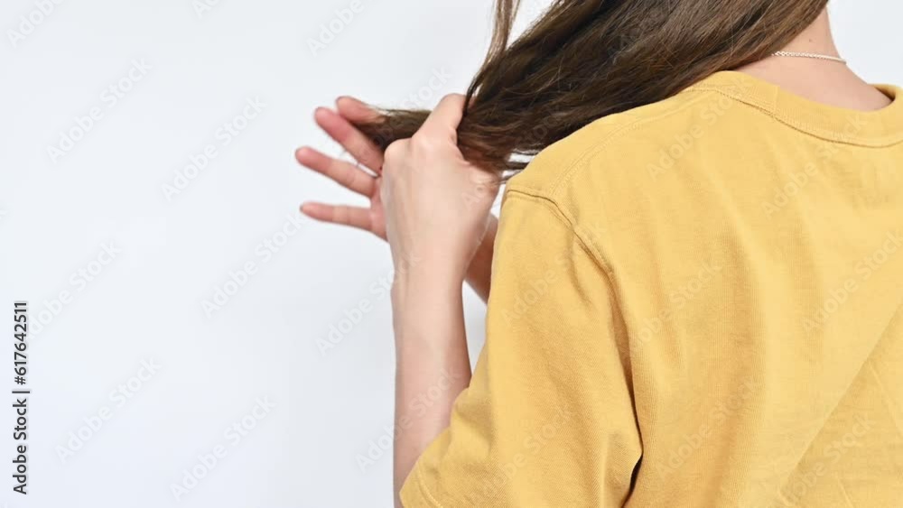 Cropped shot view of Asian woman holding and touching her split ends