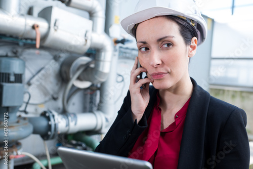 attractive businesswoman or engineer woman using phone