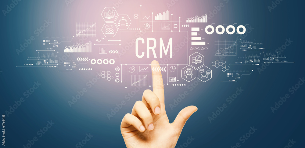 CRM - Customer Relationship Management theme with hand pressing a button on a technology screen CRM - Customer Relationship Management theme with hand pressing a button on a technology screen