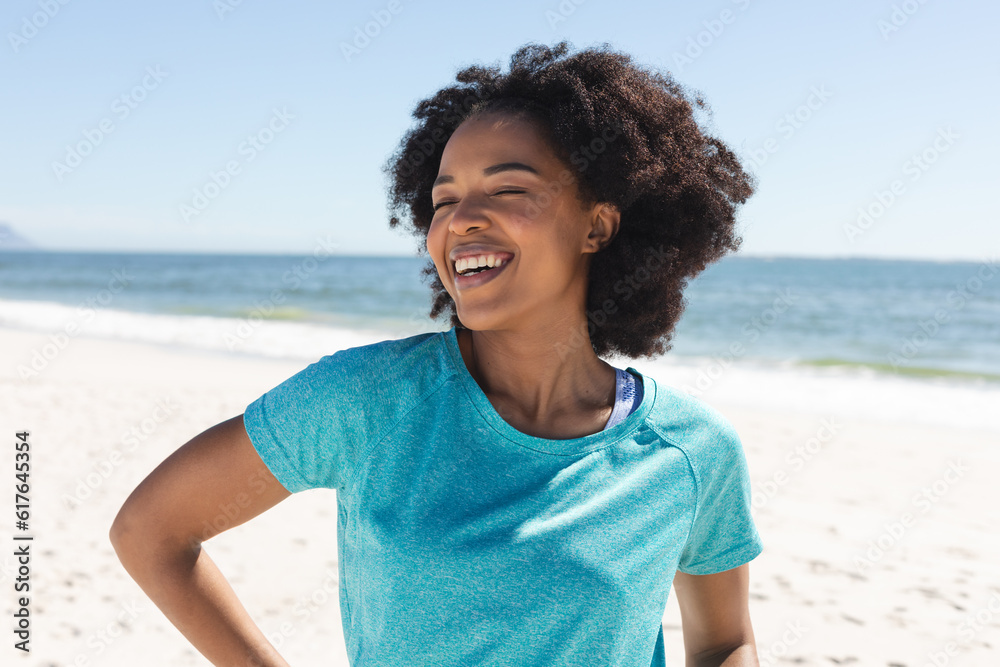 Portrait of happy african american woman looking at camera and smiling on sunny beach Portrait of happy african american woman looking at camera and smiling on sunny beach