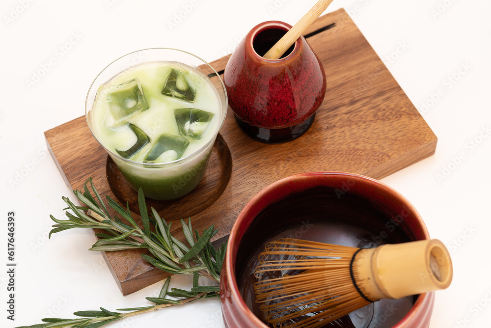 Iced matcha green tea on a weeded plate with Japanese ceramics and bamboo stick