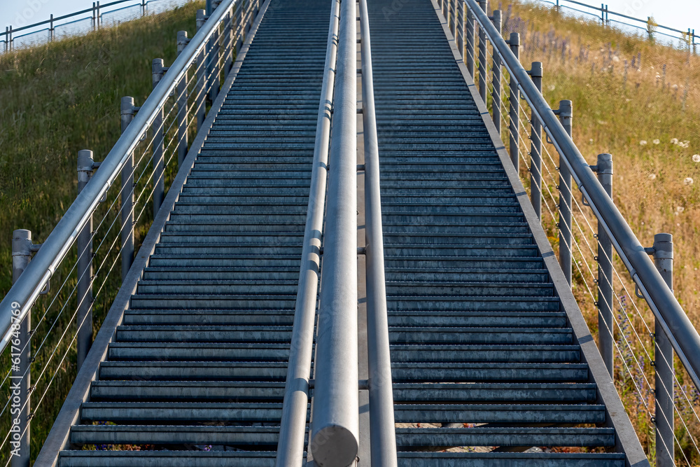 Elevated Pathways: Long Metal Staircases Ascending and Descending a Hillside for Seamless Access Elevated Pathways: Long Metal Staircases Ascending and Descending a Hillside for Seamless Access