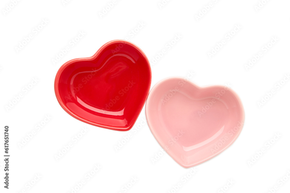 Red and pink heart shaped bowls isolated on white background.