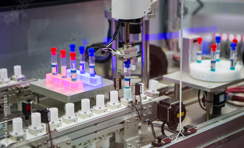Automated process in laboratory. Robot arm with test tube virus in laboratory.