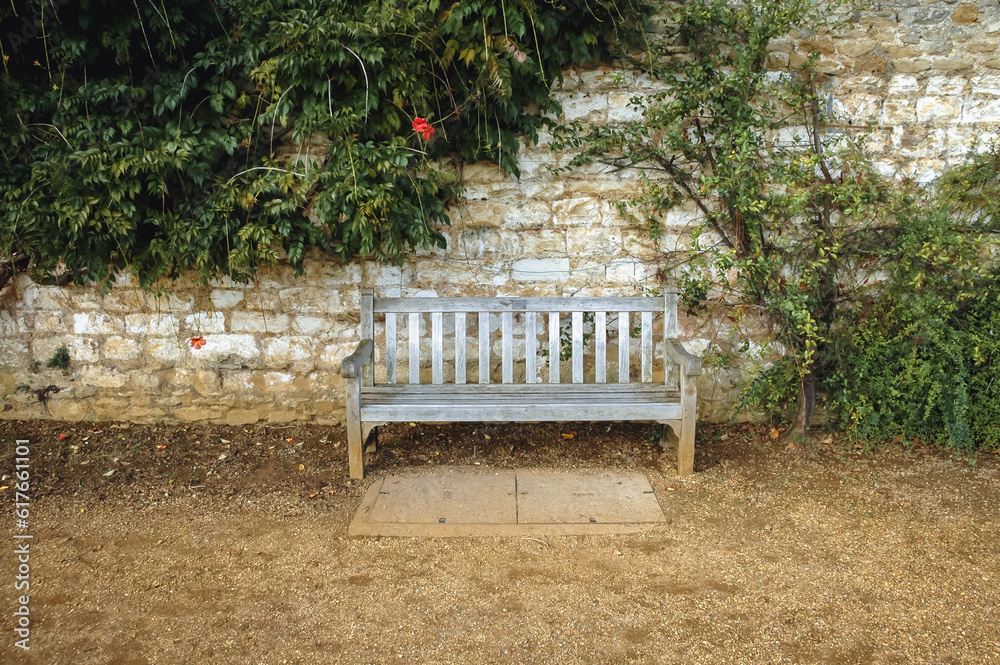 Wooden bench in King's College, constituent college of University of Cambridge, England, UK