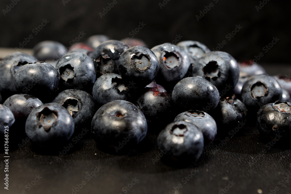 appetizing berries of ripe blueberries on a dark background appetizing berries of ripe blueberries on a dark background