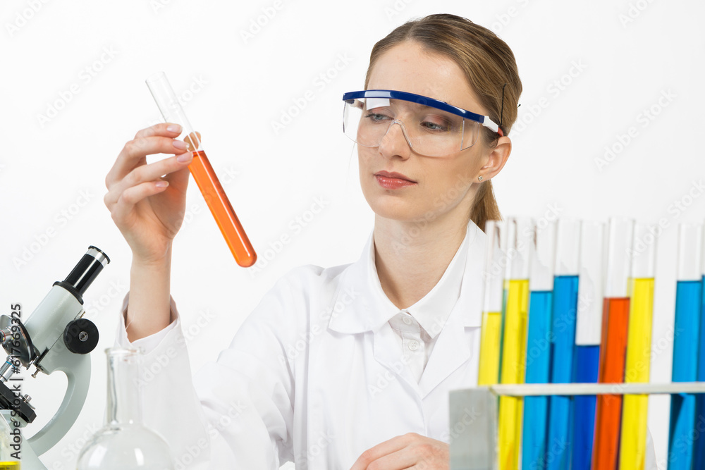 Beautiful woman scientist in protective goggles Beautiful woman scientist in protective goggles
