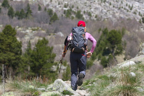 climber woman  climbs into the mountains against the backdrop of the landscape of snowy mountains