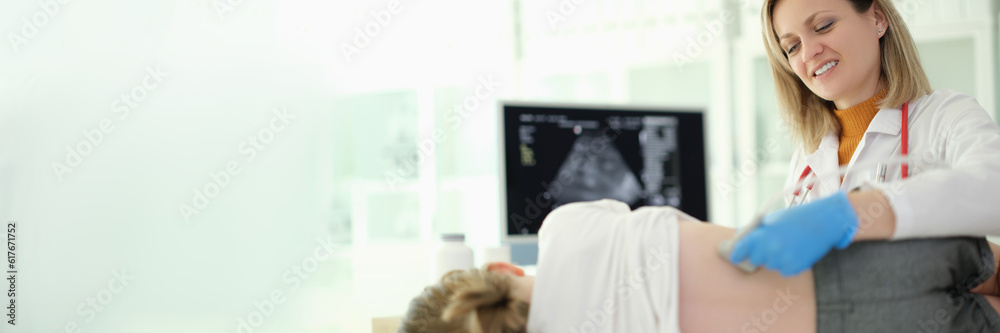Doctor pediatrician conducting ultrasound examination of kidneys of child in clinic. Instrumental diagnosis of diseases and genitourinary system in children concept Doctor pediatrician conducting ultrasound examination of kidneys of child in clinic. Instrumental diagnosis of diseases and genitourinary system in children concept