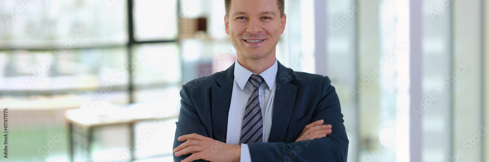 Portrait of smiling successful businessman with arms crossed. Success in business concept Portrait of smiling successful businessman with arms crossed. Success in business concept