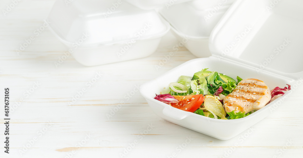 Healthy lunch box with salad and grilled chicken on white wooden background. Healthy lunch box with salad and grilled chicken on white wooden background.
