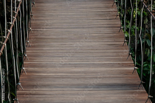 A suspension bridge that uses timber to make a walkway.